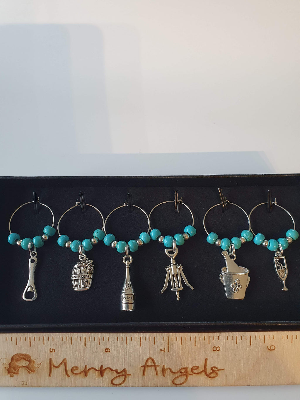 Set of 6 silver wine glass charms with turquoise beads. 