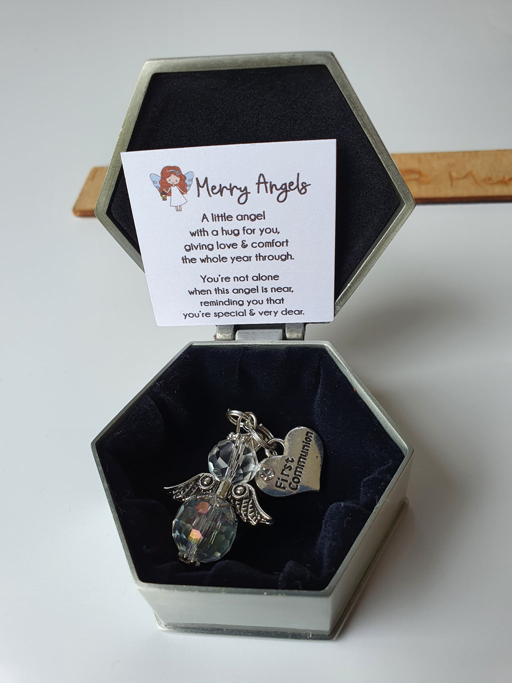 This picture shows a small angel hug with a silver first communion charm attached, There is a lovely little poem also and a beautiful silver box