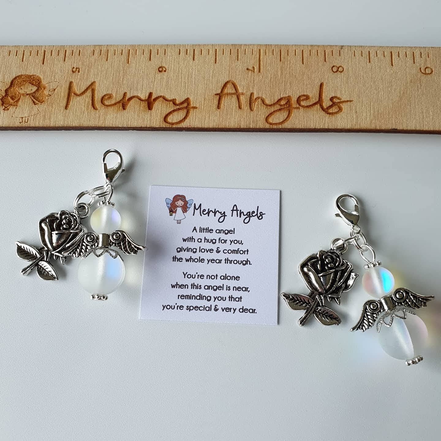 This is a picture of two angel hugs  with silver rose charms attached to both