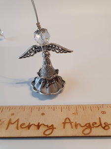 A picture of a silver coffee pod angel