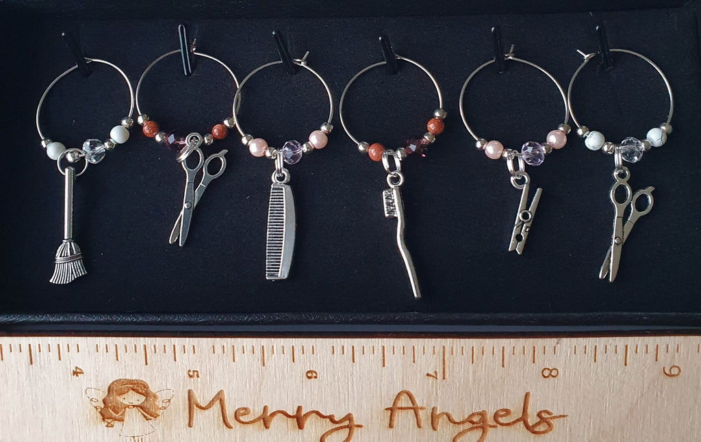 This is a picture of 6 hairdresser theme wine glass charms