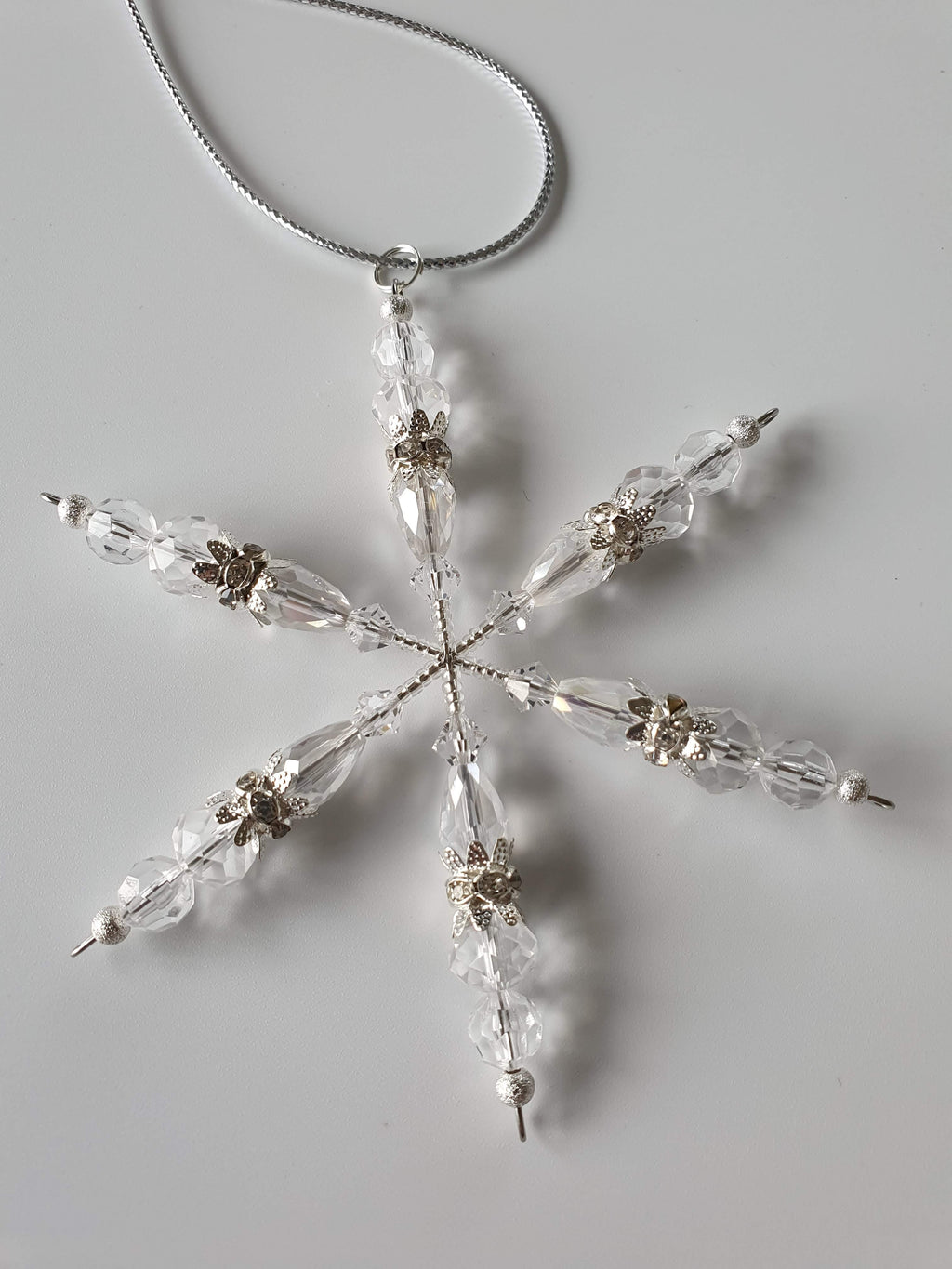 A silver snowflake with clear beads.