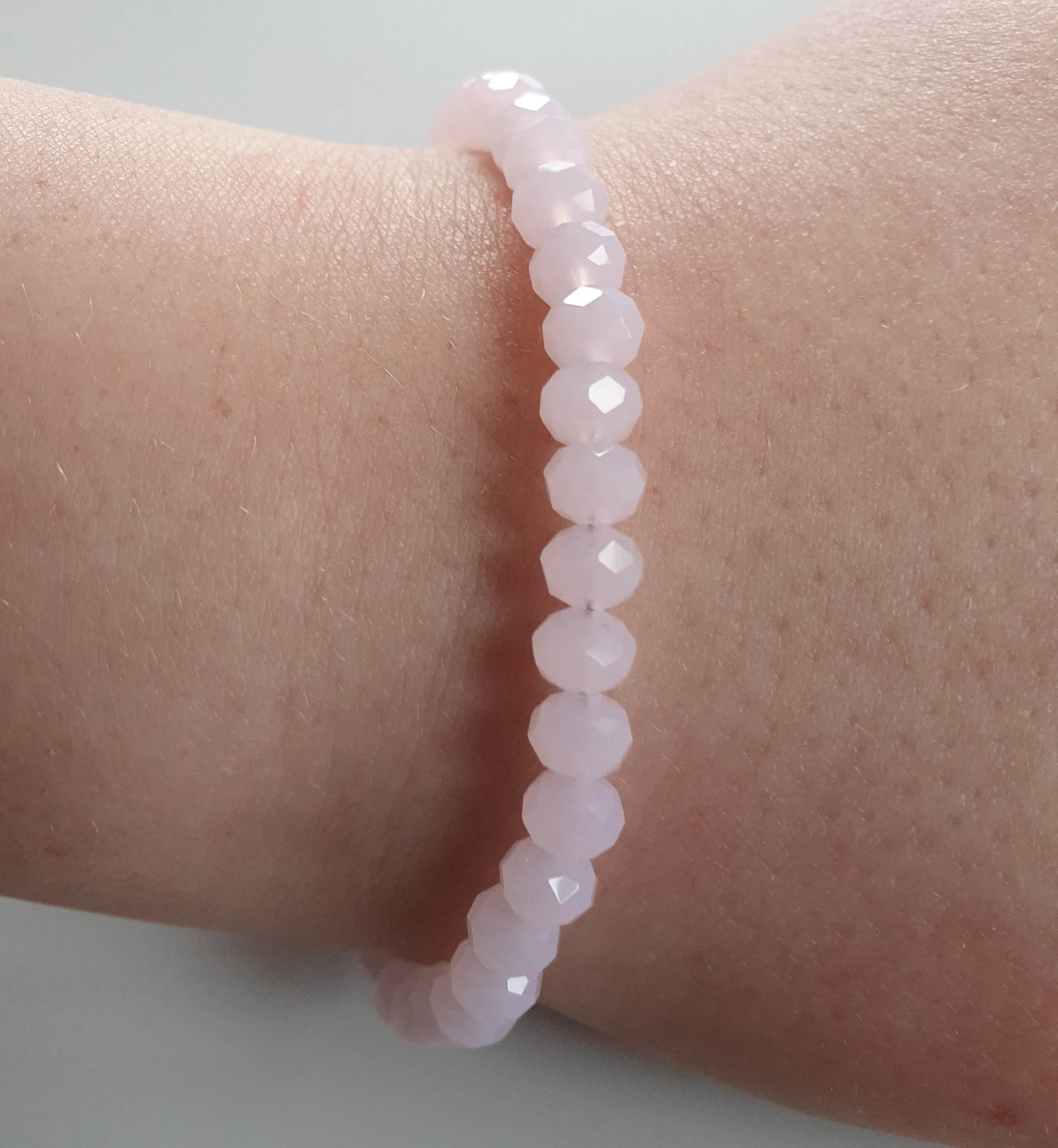 This is a picture of a baby pink bracelet on a wrist