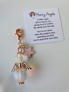 This is a picture of a clear angel hug with rose gold wings and feet and a cute rose gold and pink star charm attached. 