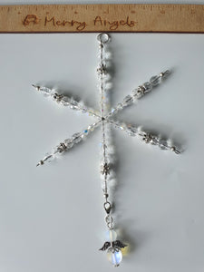 Silver star suncatcher with a clear angel with silver wings hanging from the bottom of it. 
