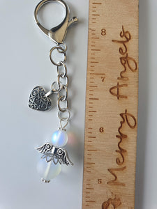 This is a picture of a silver angel keyring with a silver heart attached
