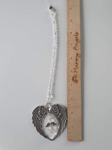This is a picture of a silver angel wing hanging charm