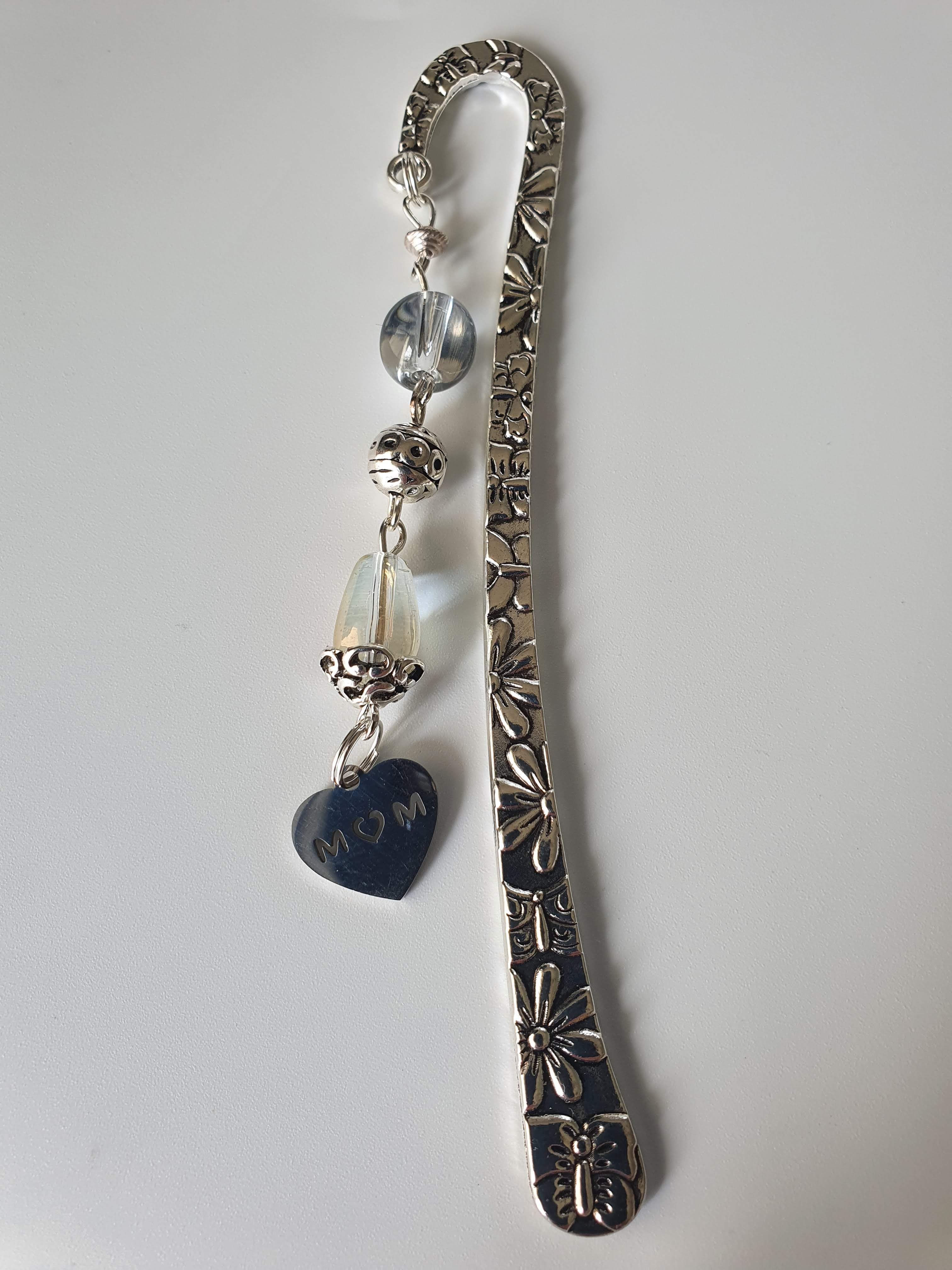 This is a picture of a silver bookmark with a 'mom' charm 