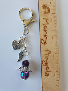 This is a picture of a silver angel keyring with two silver charms. The angel is purple