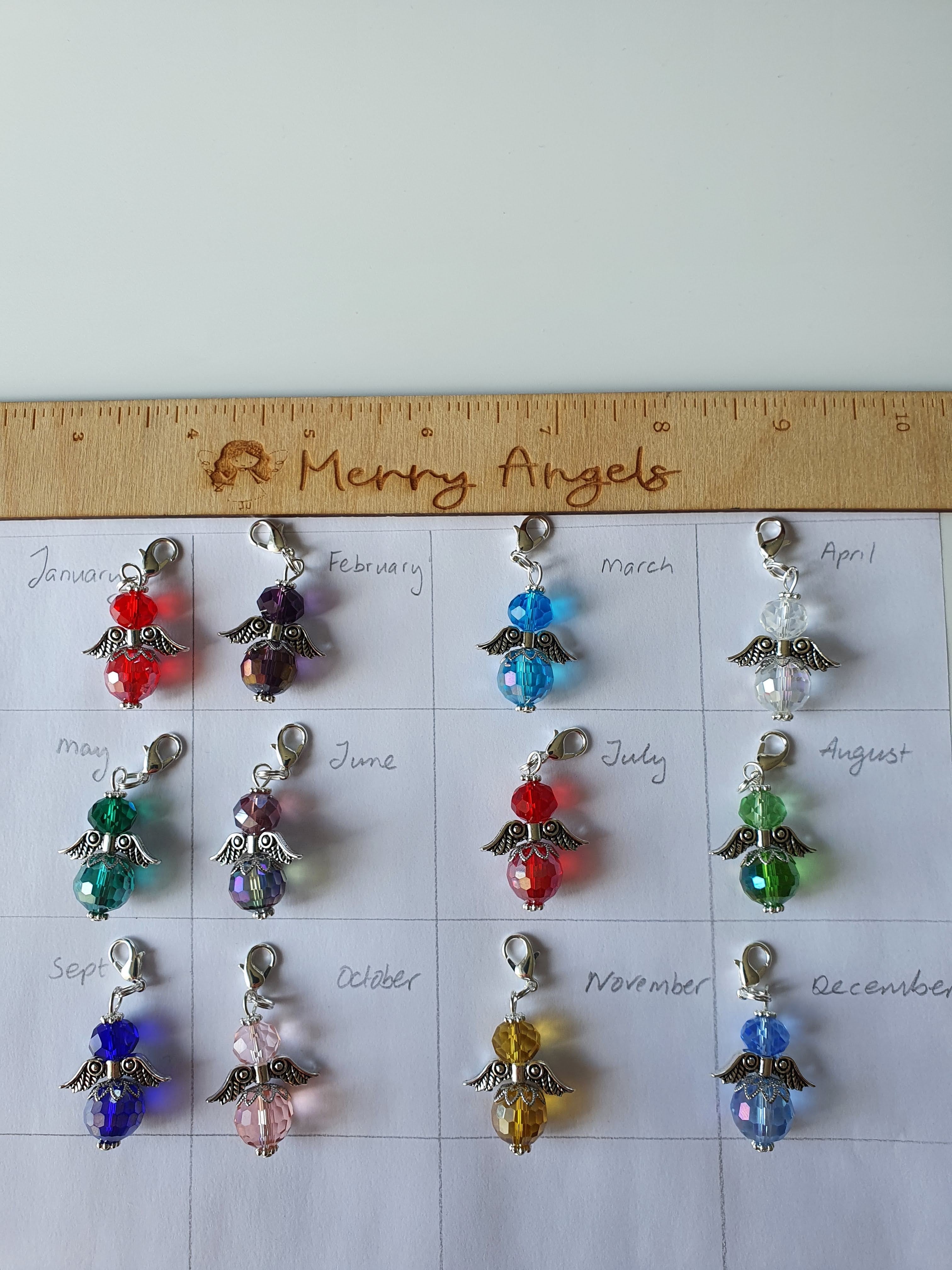 This is a picture of 12 angel hugs in various colours. The angel hugs are in the various birthstone colours. There is one for each month. 