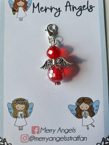 This is a picture of a red angel hug on a piece of card