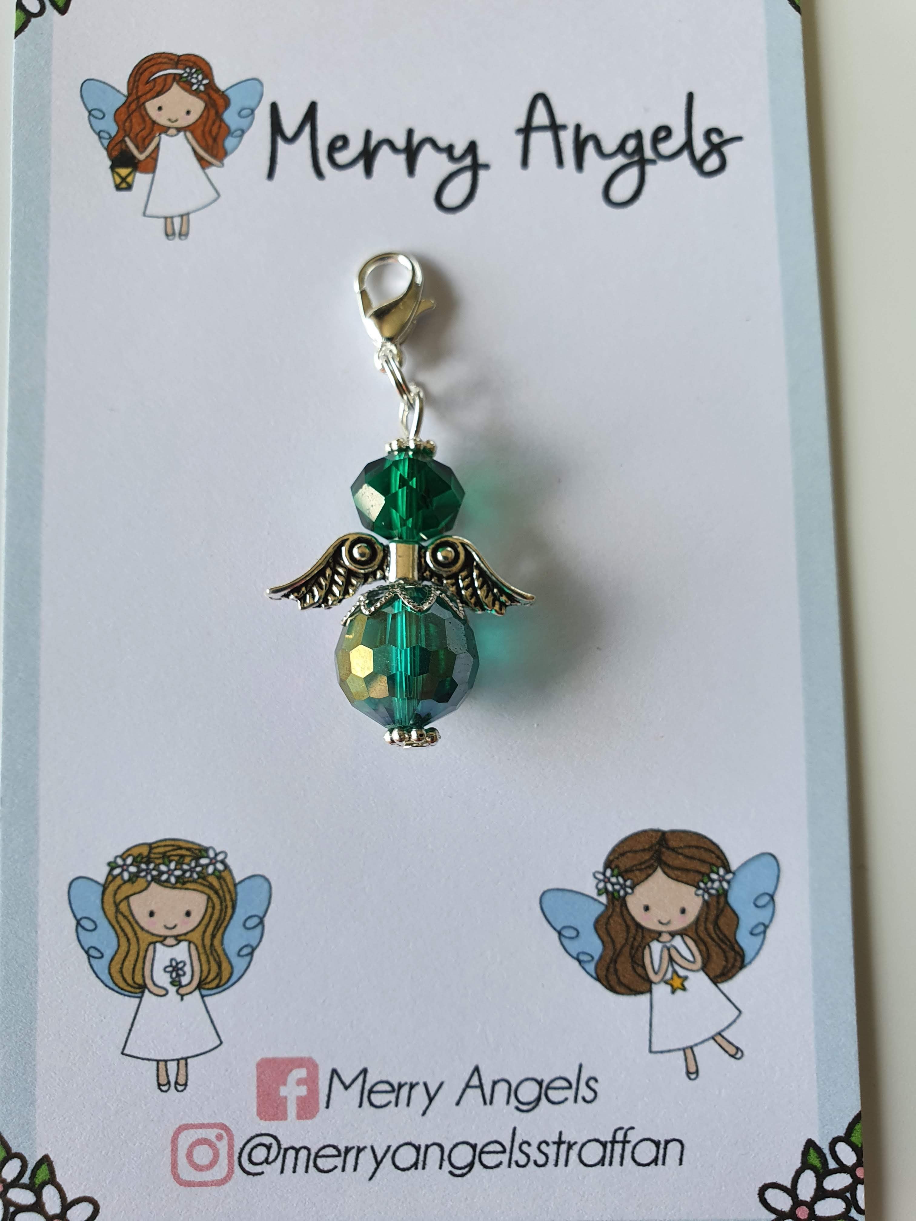 This is a picture of a green angel hug on a piece of card