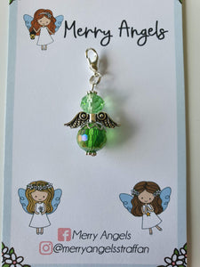 This is a picture of a green angel hug on a piece of card