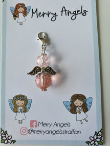 This is a picture of a pale pink angel hug on a piece of card