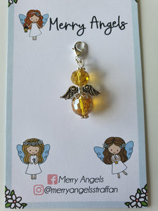 This is a picture of a yellow angel hug on a piece of card