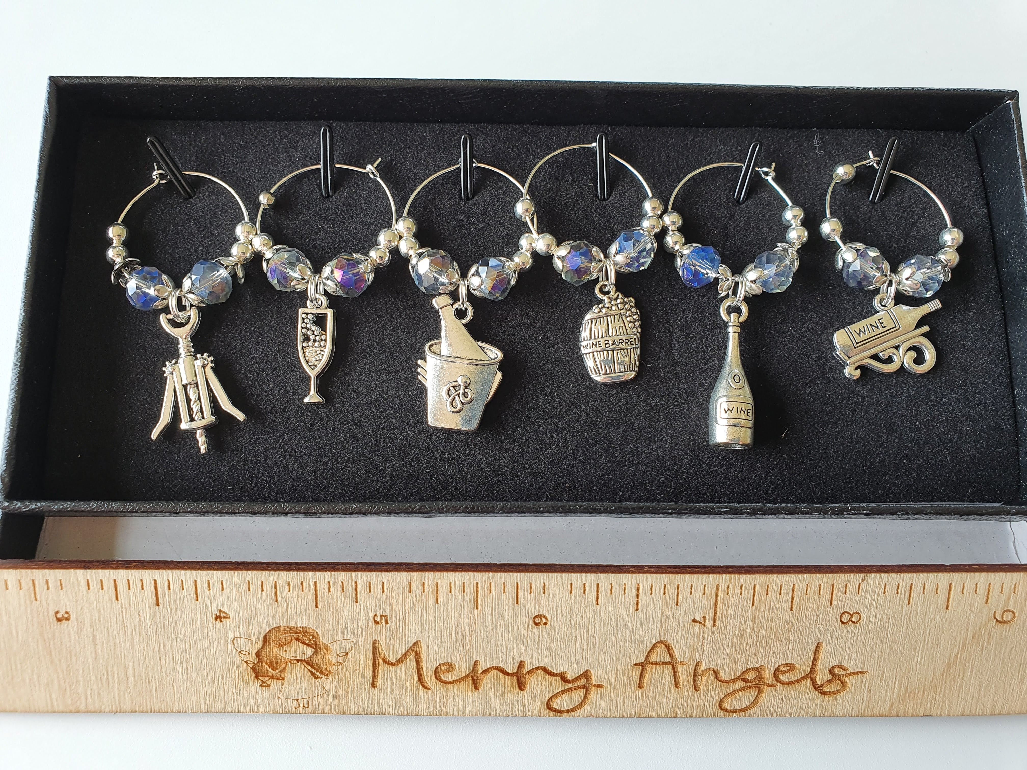 A set of 6 silver wine glass charms.