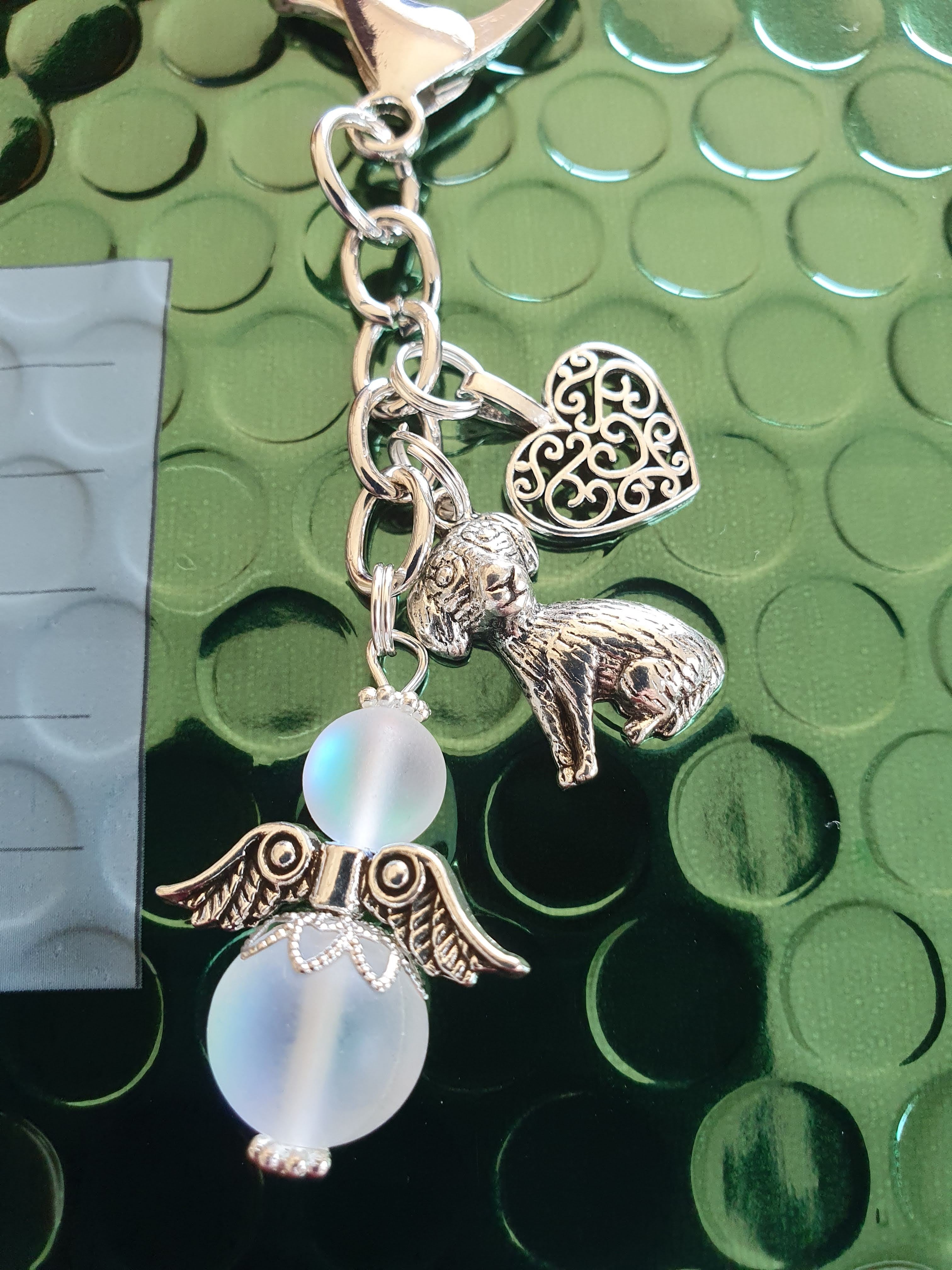 This is a picture of a silver angel keyring with beautiful silver charms