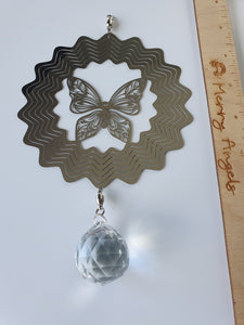 Silver butterfly wind spinner with clear glass crystal hanging from the bottom. 