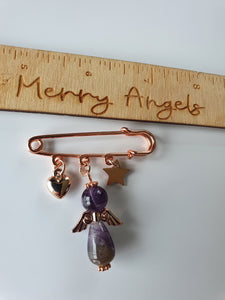Rose gold brooch with heart charm, star charm and beautiful amethyst angel attached to it. 