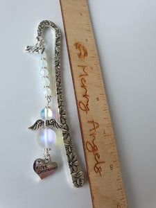 Beautiful silver bookmark with a first communion heart charm, a 2021 charm, and clear angel