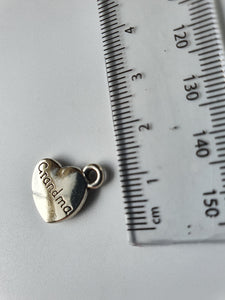 Silver charm with 'Grandma' engraved on it