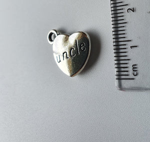 Silver charm with 'uncle' engraved on it