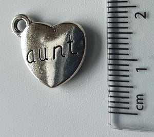 Silver charm with 'aunt' engraved on it