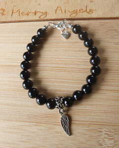 Black beaded bracelet wing charm