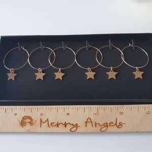 Set of 6 rose gold wine glass charms with stars. 
