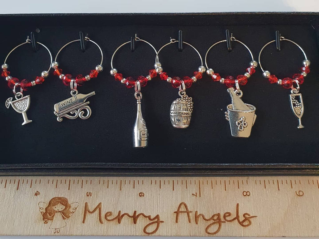 This is a picture of 6 silver and red wine glass charms.