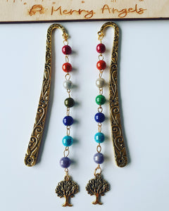 Two gold bookmarks with rainbow beads and tree of life charm at the bottom of each bookmark. 