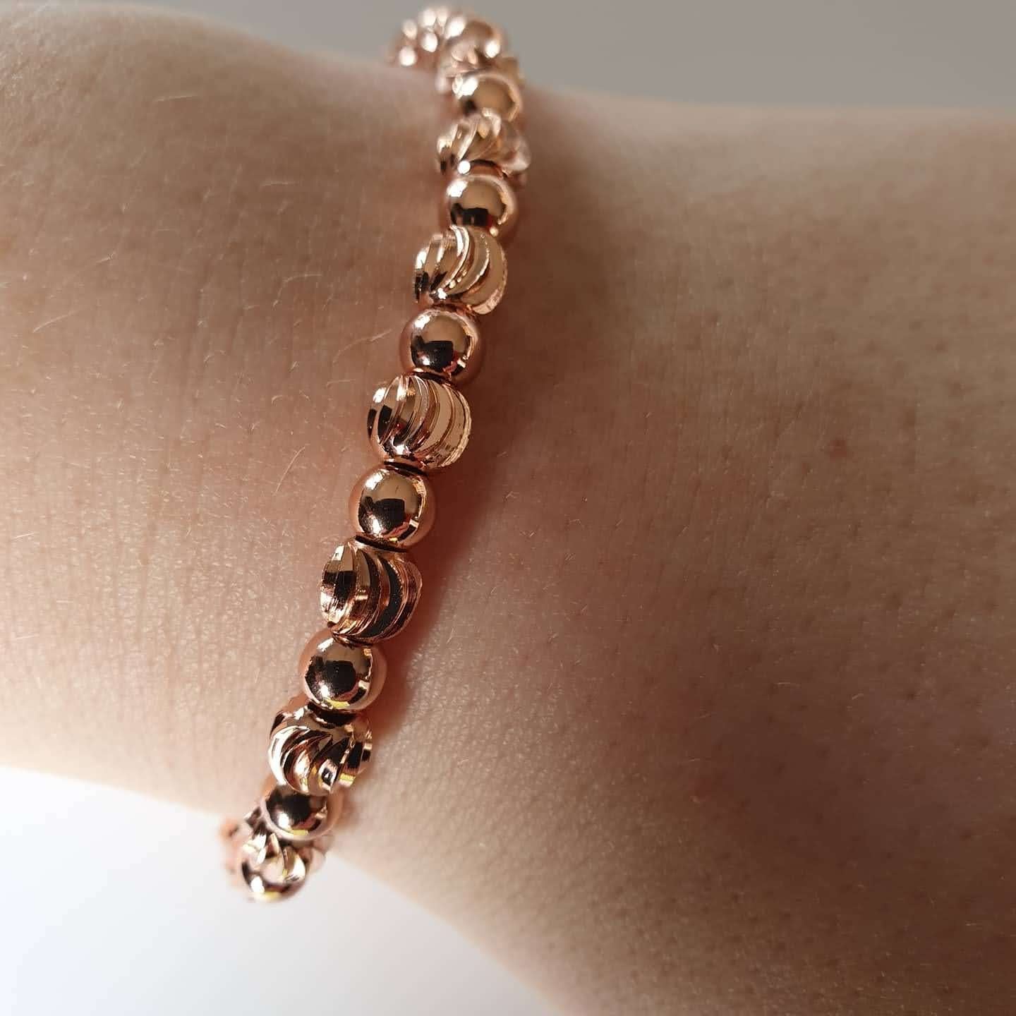 This is a picture of a rose gold bracelet on a wrist