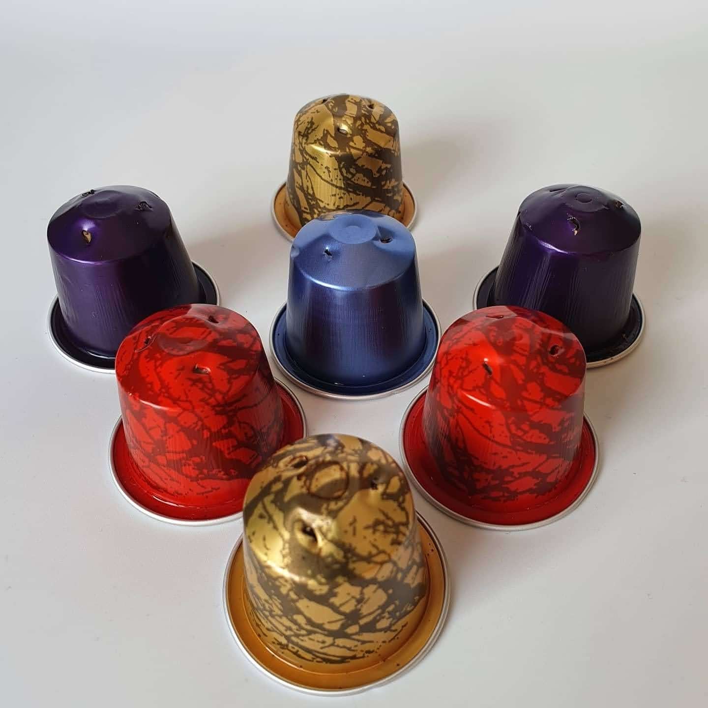 A picture of seven coffee pods in various colours