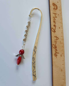 This is a picture of a silver bookmark with a red angel