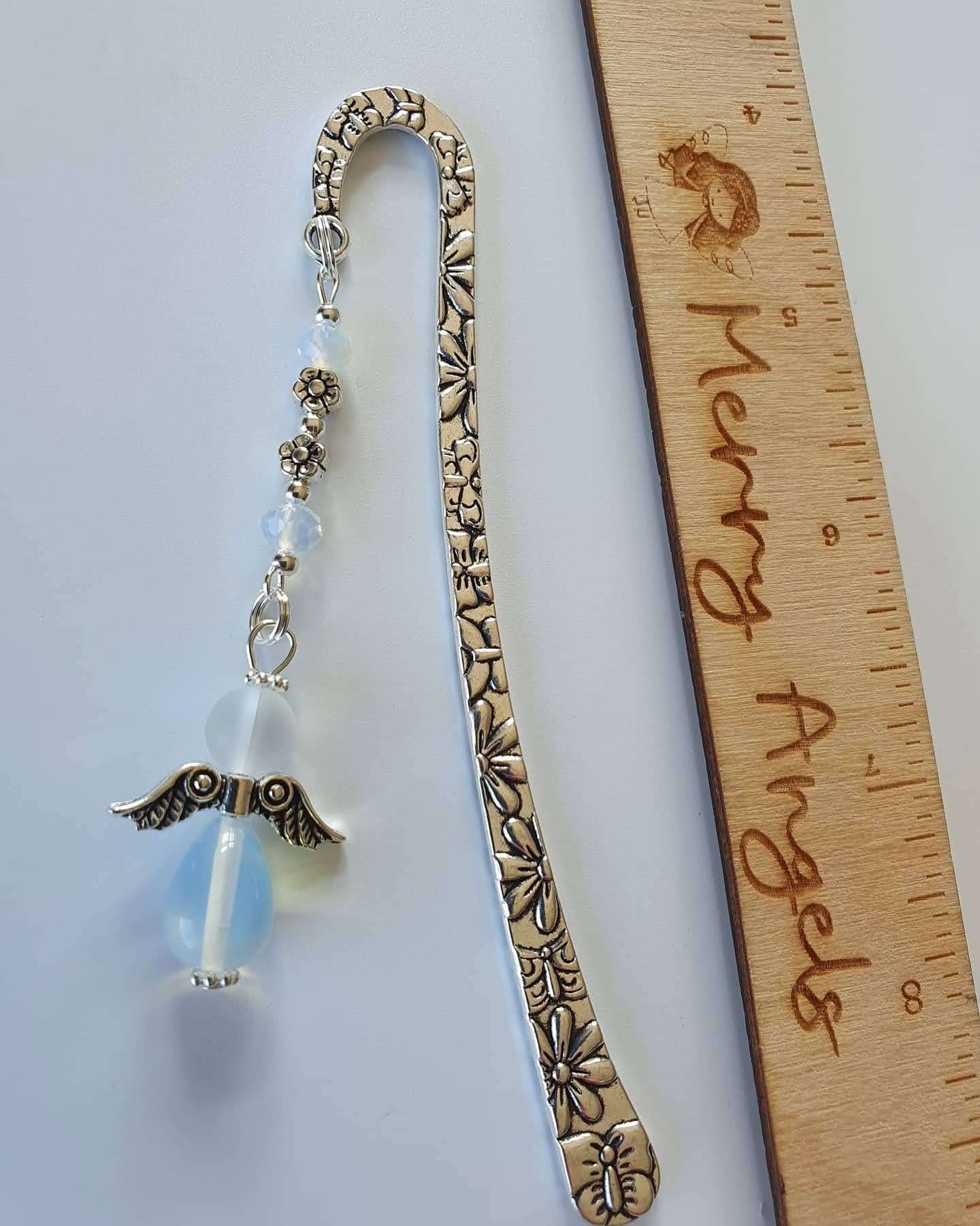 This is a picture of a silver bookmark with a clear angel