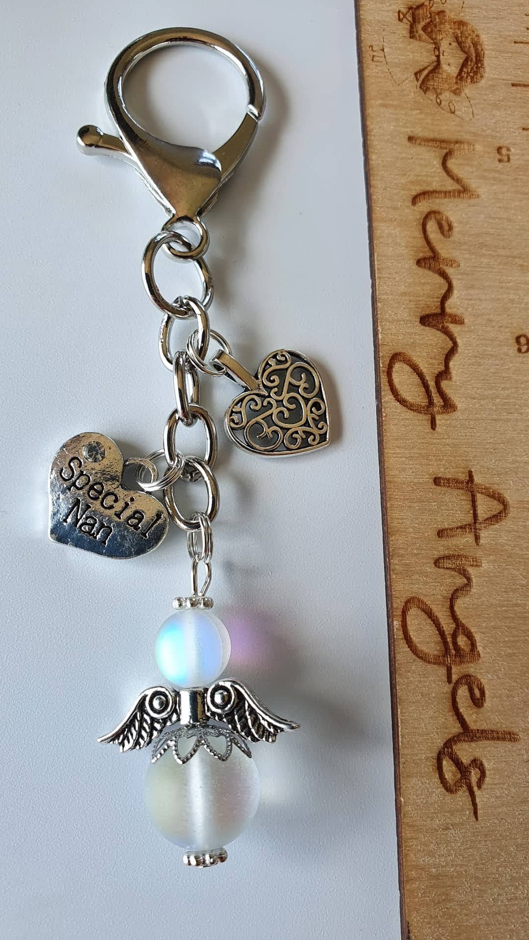 This is a picture of a silver angel keyring with beautiful silver charms