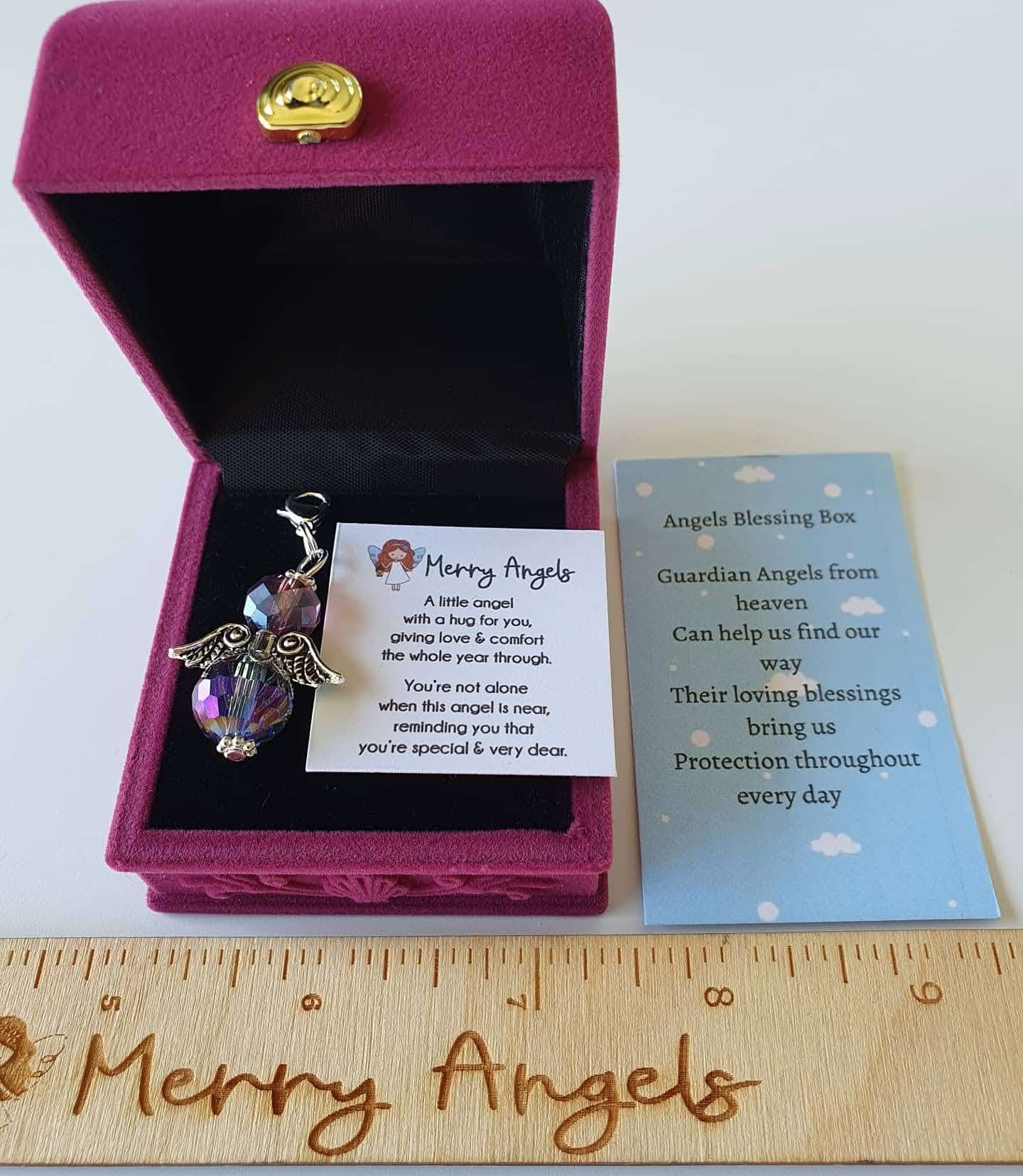 This picture shows an angel hug in a beautiful pink box with a poem about angels printed on a piece of card, and another little card with a saying about guardian angels printed on it. 